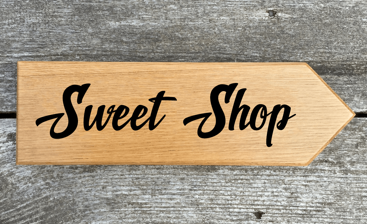 Sweet Shop Sign pointing towards the right