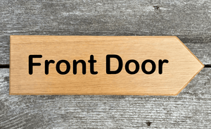 Front Door Sign pointing towards the right