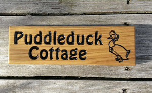 Small Thin House Sign saying puddleduck cottage with a duck image FONT: HOBO