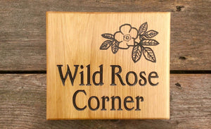 Square House Sign saying wild rose corner with a flower picture FONT: EDWARDIAN